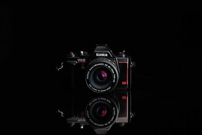Close-up of camera against black background