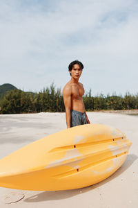 Shirtless man swimming in sea