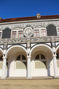 Low angle view of building against clear blue sky