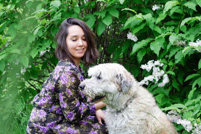 Portrait of a smiling young woman with dog