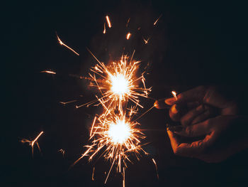 Low angle view of firework display at night