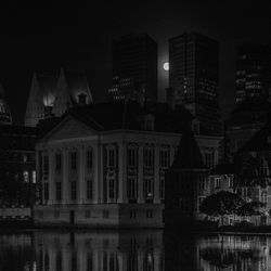 Reflection of illuminated buildings in city at night