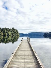 Pier over lake against sky