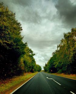 Scenic view of road against cloudy sky