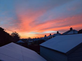 Silhouette buildings against sky during sunset