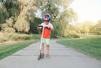 Boy with umbrella on road