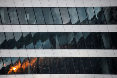 Low angle view of glass building against sky