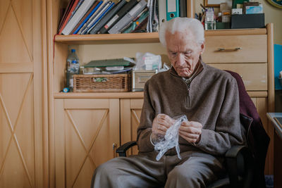 Man sitting on chair at home