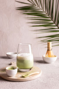 Green tea matcha latte on a white stone board