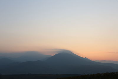 Scenic view of silhouette mountains against sky during sunset