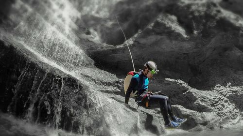Full length of man jumping on rock