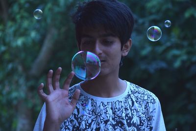 Close-up of boy playing with bubbles