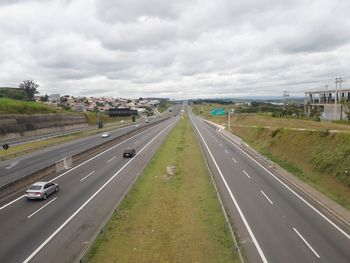 High angle view of highway against cloudy sky