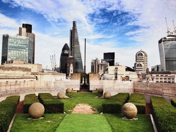 Modern buildings against cloudy sky