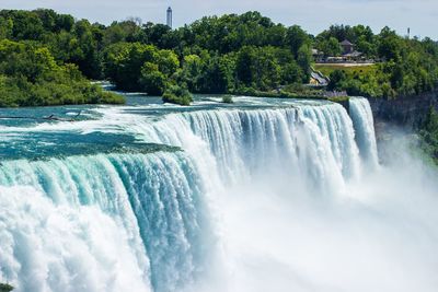 Scenic view of waterfall against sky
