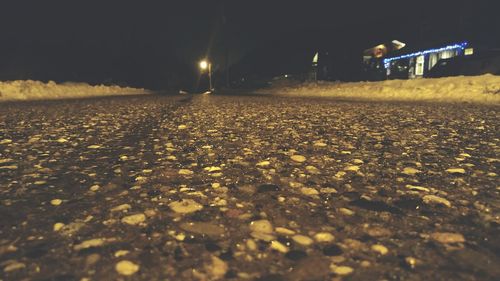 Illuminated road against sky at night