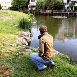 Rear view of woman standing in pond