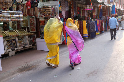 Rear view of people walking on street