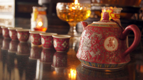 Close-up of illuminated candles on table