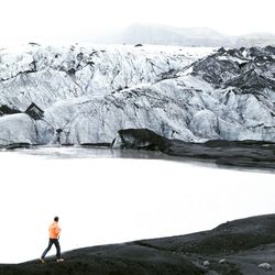 Woman standing on snow covered field