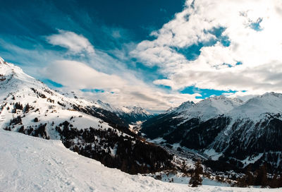 Scenic view of snowcapped mountains against sky