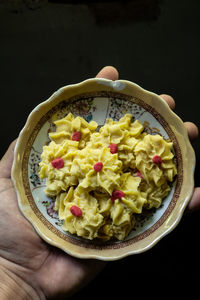 Close-up of hand holding fruit salad