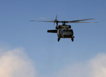 Low angle view of helicopter against sky