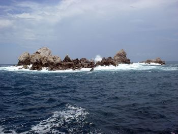 Mexico scenic view of rocks in sea against sky