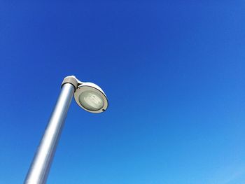 Low angle view of street light against clear blue sky