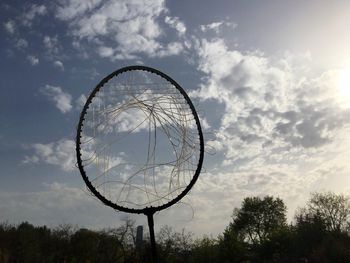 Low angle view of ferris wheel against sky