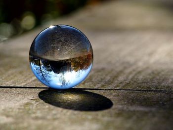 Close-up of crystal ball on wooden surface