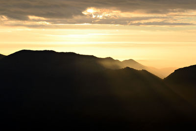 Scenic view of silhouette mountains against sky during sunset