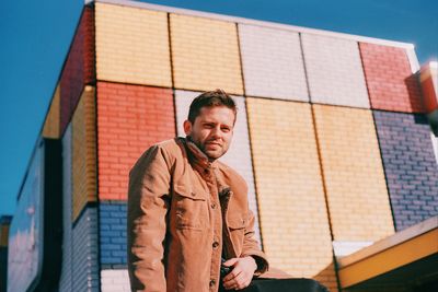 Low angle view of man standing against building