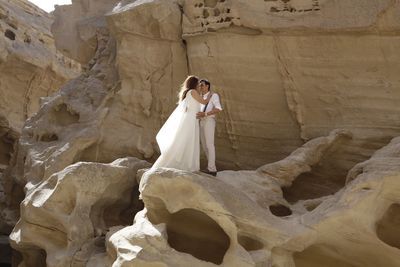 Full length of woman standing on rock