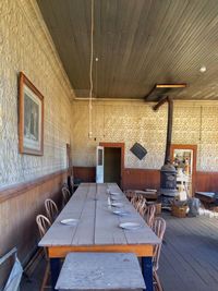 Empty chairs and table against wall at home