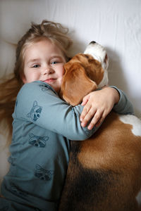 Cute baby girl with dog at home