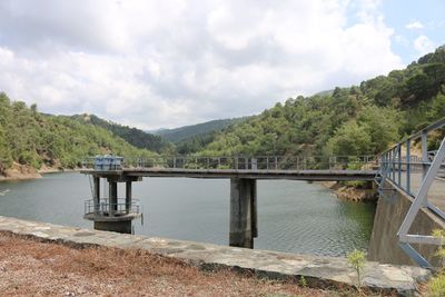 Bridge over lake against sky