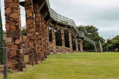 Old ruin building on field against sky