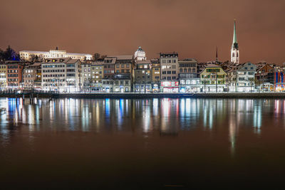 Reflection of illuminated buildings in city at night