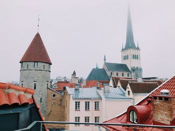 Buildings in city against clear sky