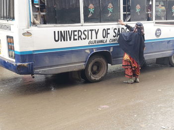 Rear view of man standing on road