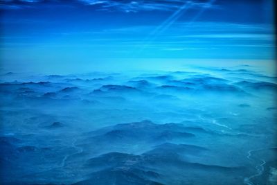 Scenic view of sea against blue sky