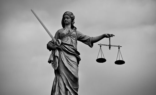 Low angle view of statue against sky