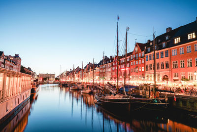 An evening in copenhagen by the famous place nyhavn. colorful houses and reflections.