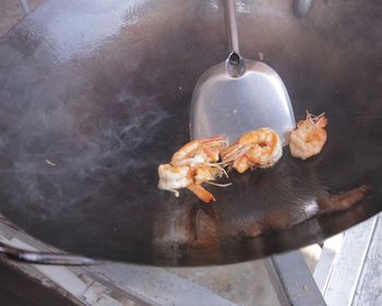 High angle view of meat cooking on barbecue grill