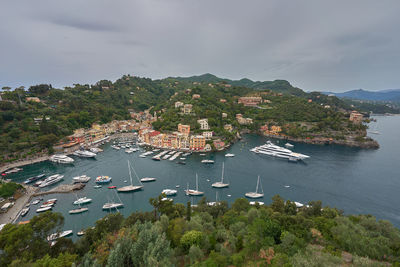 High angle view of townscape by sea against sky