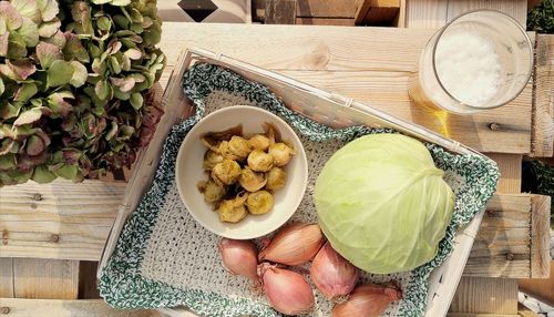 High angle view of woman holding food on table