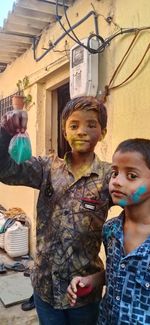 Portrait of cute smiling girl standing outdoors