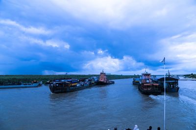 Boats moored in sea against sky