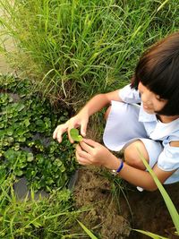 High angle view of girl holding umbrella on field